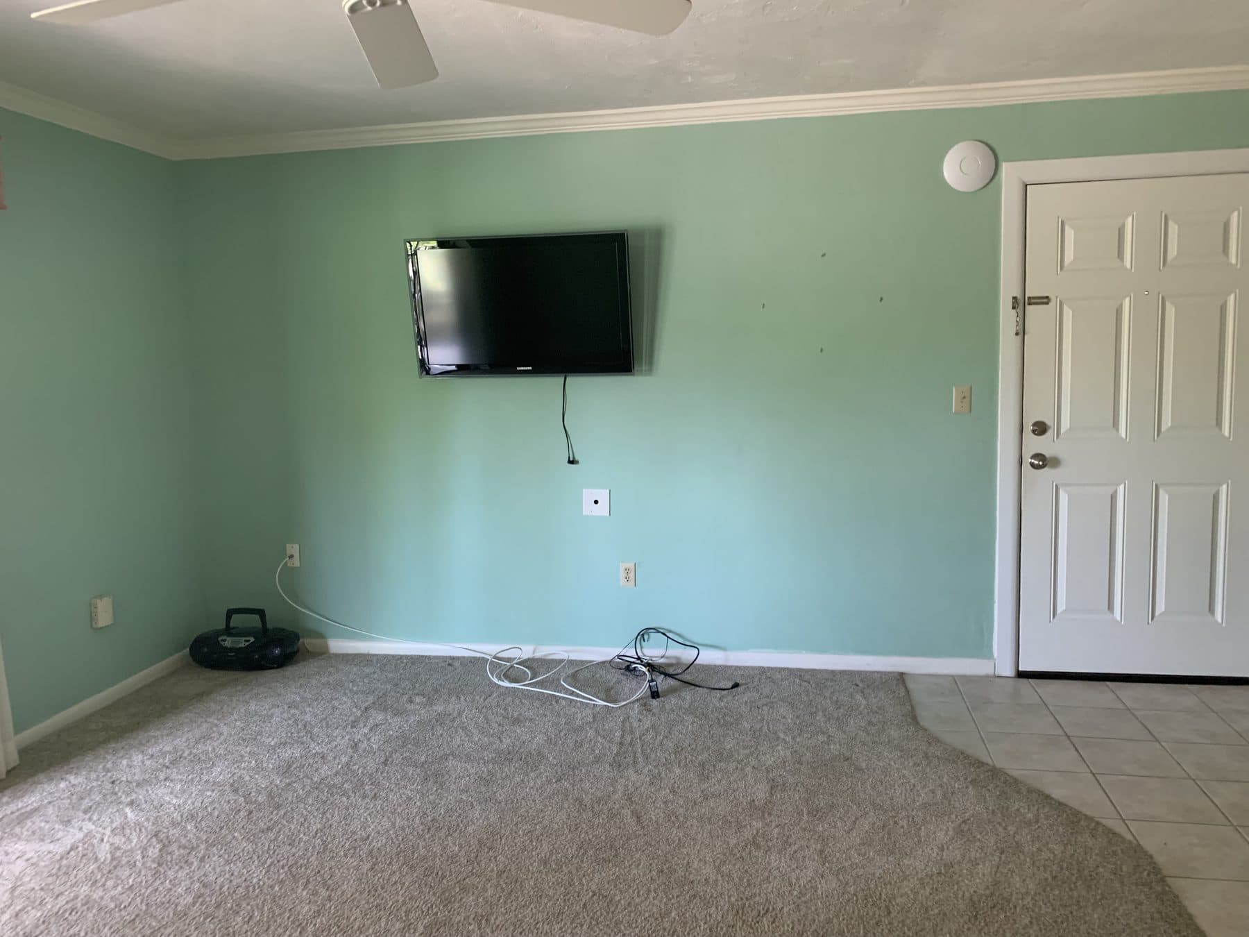 Empty living room with wall-mounted TV
