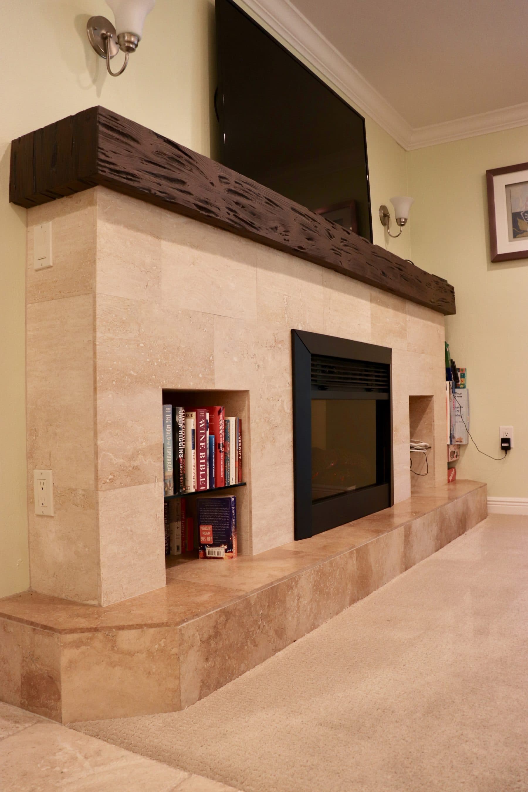 Stone fireplace with built-in shelving and TV