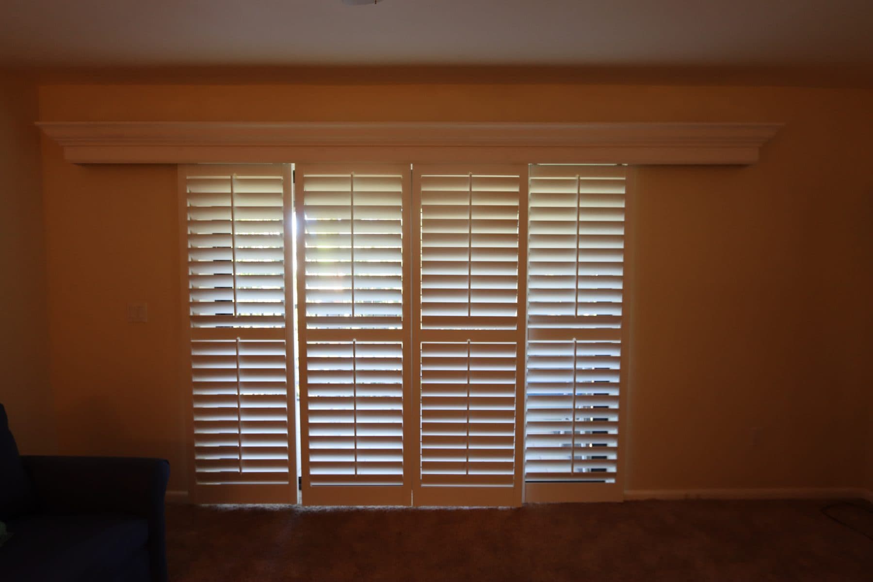 Room with plantation shutters in warm evening light